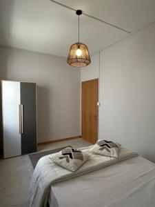 a room with a bed with a lamp and a door at Alizé Mont Choisy in Mont Choisy +15 photos
