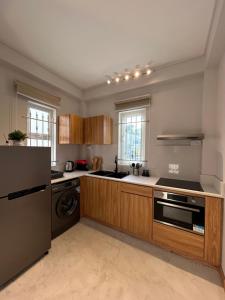 a kitchen with a sink and a dishwasher at Alizé Mont Choisy in Mont Choisy
