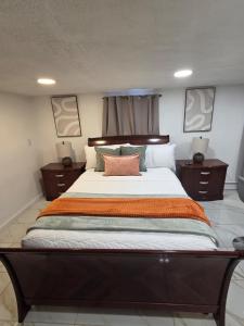 a bedroom with a large bed with two night stands at Tropical Oasis in Rosedale