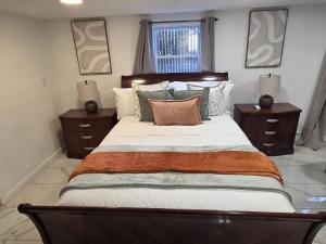 a bedroom with a large bed with pillows and a window at Tropical Oasis in Rosedale