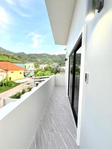 a white balcony with a view of a city at Hana residence Bangtao BeachBangtao 11 Phuket in Ban Thalat Choeng Thale