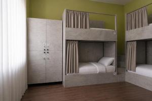 two bunk beds are in a room with at Nomad Aktau Hostel in Aktau
