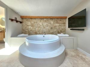 a large bathroom with a large tub and a tv at Suite Amoriya in Camblanes-et-Meynac +6 photos