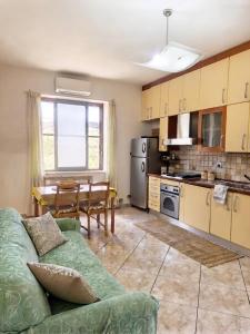 a living room with a couch and a kitchen at Appartamenti Camerota in Camerota