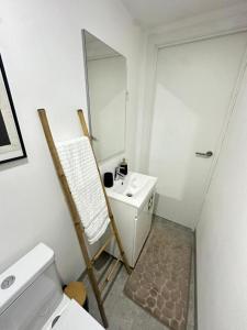 a bathroom with a toilet and a sink and a mirror at Casa do Apeadeiro in Vila Pouca de Aguiar +56 photos