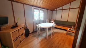 a room with a table and chairs and a window at Chalet LE BAUSOY in Tournavaux