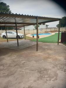 a pavilion with a car parked next to a park at Ocean Wave Chalets Unit 1 in Hibberdene