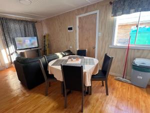 a dining room with a table and chairs and a couch at CasasAnique in Cañete