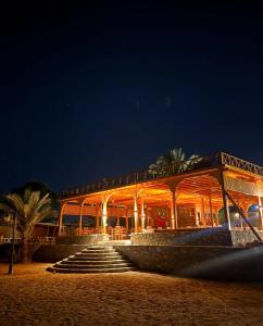 a building on the beach at night at Mermaid camp in Nuweiba