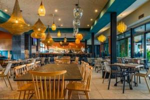 a restaurant with tables and chairs and a bar at Aurevia Properties in Pretoria