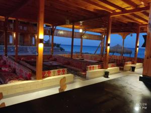a pavilion with red seats on the beach at Mermaid camp in Nuweiba