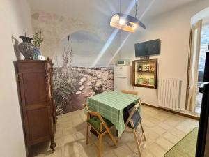 a dining room with a table and a refrigerator at Gemma Del Sud - Centro Storico in Conversano