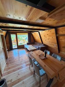 a large wooden room with a wooden table and chairs at Vikendice Pod Hum Kučka Korita in Korita