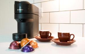a coffee maker with two cups and some eggs at Cuil Steading in Cairndow