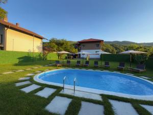 a swimming pool in a yard with chairs and a house at Villa Maria in Ribarica