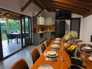 a kitchen and dining room with a wooden table and chairs at Villa Maria in Ribarica