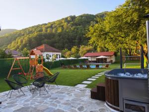 a backyard with a playground with chairs and a swing at Villa Maria in Ribarica