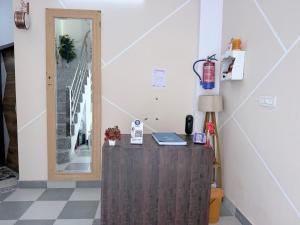 a room with a desk with a lamp and a mirror at Drip Home Stay AKTU in Lucknow