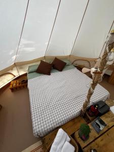 a bed in a tent on a boat at S'incantu in Burgos