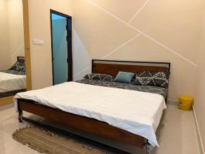 a bedroom with a bed and a mirror at Drip Home Stay AKTU in Lucknow +65 photos