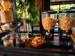 a table with two containers of food and snacks at The Art Hotel El Poblado Medellín By Key 33 in Medellín