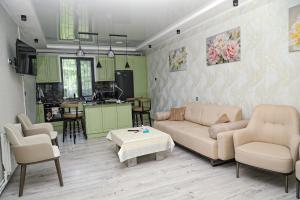 a living room with a couch and chairs and a table at EVORI Guesthouse in Dilijan
