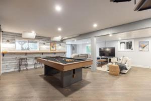a large living room with a pool table in it at 5-Br Villa on Lake Labelle Chalet Jacob in Labelle
