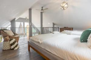 a bedroom with a large bed and a balcony at 5-Br Villa on Lake Labelle Chalet Jacob in Labelle