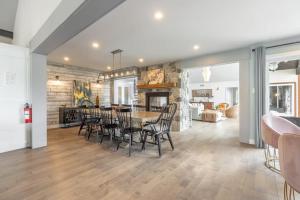 a dining room and living room with a table and chairs at 5-Br Villa on Lake Labelle Chalet Jacob in Labelle