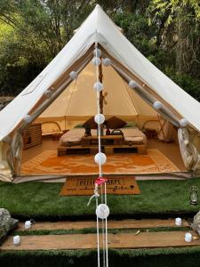 a white tent with a bed in it at S'incantu in Burgos