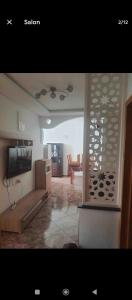 a living room with a television and a couch at Appartement agadir centre in Agadir