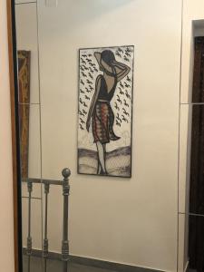 a painting of a woman on a wall at Rifugio Escursionistico Locanda Borgo Villa in Acceglio +18 photos