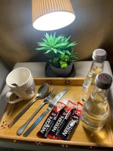 a tray with silver utensils and a bottle of water at Holiday Abu Dhabi in Abu Dhabi