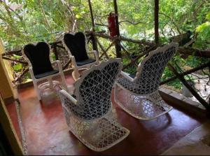 a group of chairs sitting on a porch at Hostal Doña Chava in Pedernales