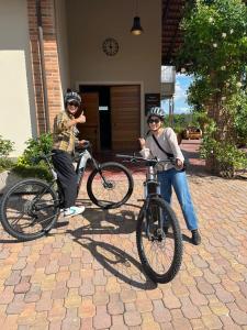 two people wearing helmets standing next to their bikes at Braida Wine Resort in Rocchetta Tanaro