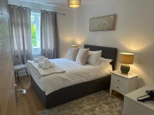 a bedroom with a bed with white pillows and a window at Northway Apartment's in Oxford