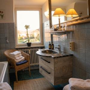 a bathroom with a sink and a window and a tub at Der Platengarten in Ansbach +172 photos