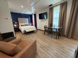 a bedroom with a bed and a table and a couch at Historic Tomahawk in Green River