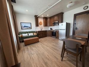 a kitchen and living room with a couch and a table at Historic Tomahawk in Green River
