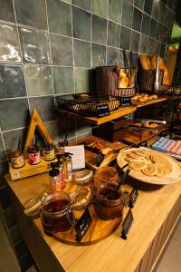 a counter with many different types of food on it at Grand Mercure SP Pinheiros in São Paulo
