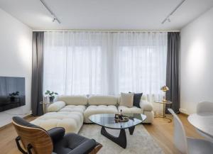 a living room with a white couch and a table at City Choice Apartment in Helsinki