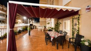 a dining room with a table and chairs under a canopy at 2 bedroom flat 100m from the beach with huge terrace in Moncófar