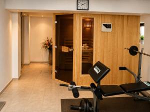 a room with a gym with a treadmill at Семеен хотел Forest Retreat Mountain Resort in Kyustendil
