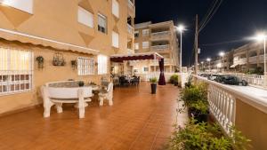 a balcony with a tub and a table and chairs at 2 bedroom flat 100m from the beach with huge terrace in Moncófar
