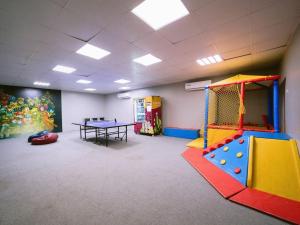 a gym with a play room with a table at Hideout Farmhouse - By Seven Elements in Ras al Khaimah