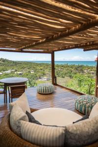 a living room with a view of the ocean at Casa La Torre Hotel Boutique in Trancoso