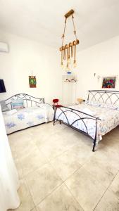 a bedroom with two beds and a chandelier at Relax House in Bari