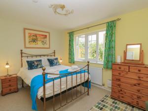 a bedroom with a bed and a dresser and a window at Evergreen in Broadway