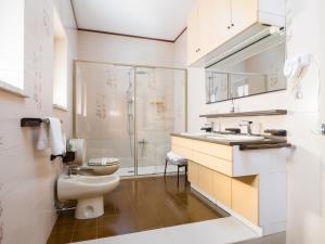 a bathroom with a toilet and a sink and a shower at Villa Francesca Luxury Rooms in San Demetrio Corone +27 photos