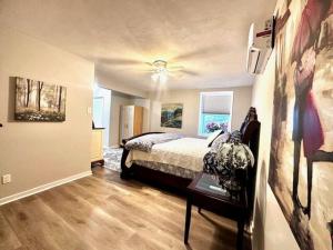 a bedroom with a bed and a table in it at Cozy Hideaway guest suite in Midlothian